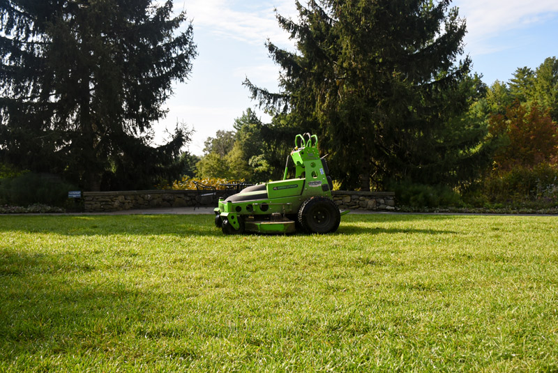The electric mower rests in the Secret Garden post mowing.