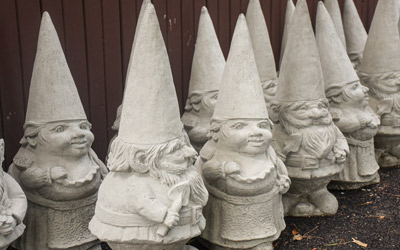 Concrete gnomes sit lined up outside the horticulture barn.