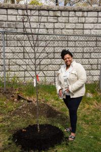 Jackie Harris smiling with her new redbud tree.