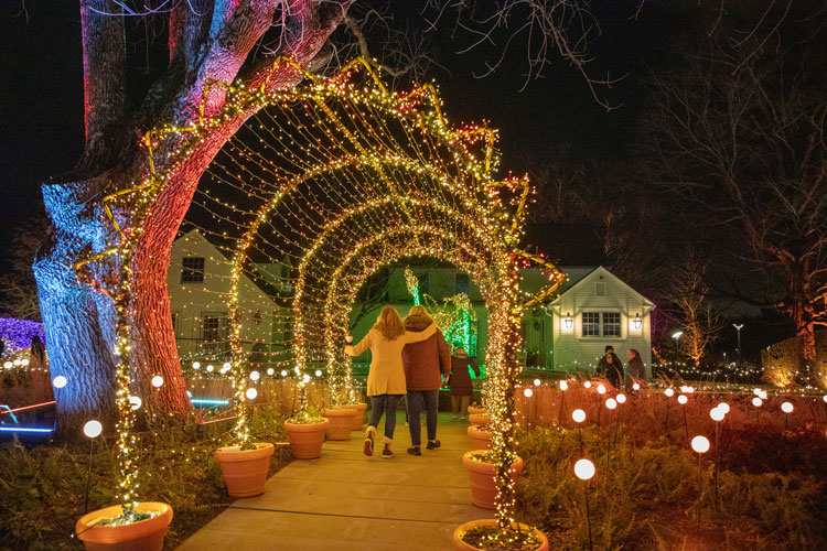 Visitors posing for a photo in the sun tunnel from Night Lights 2023.