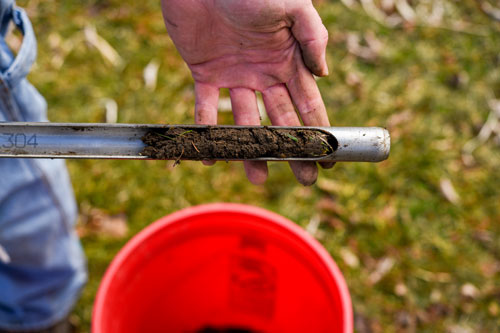 A soil sample is in view, being held by the Garden's land steward. The soil will be tested for nutrients.