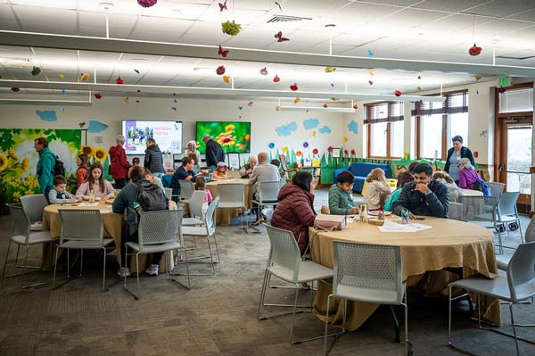 A room filled with visitors with bug decorations for April Vacation week.