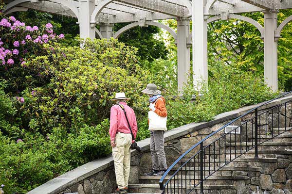 Visitors walking down the stairs into the Secret Garden during the springtime.
